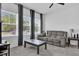 Cozy living room with comfortable seating, large windows, and neutral color scheme at 3039 Springwell Loop, Orlando, FL 32808