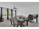 Comfortable living and dining space with neutral decor, modern fan and three large windows at 3039 Springwell Loop, Orlando, FL 32808