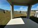 Relaxing back patio overlooking a serene pond and green space at 34071 Sky Blossom Cir, Leesburg, FL 34788