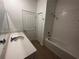 Bathroom featuring a shower over tub, tile floors, large vanity, and a linen closet at 34071 Sky Blossom Cir, Leesburg, FL 34788