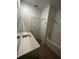 Bathroom featuring a shower over tub, tile floors, large vanity, and a linen closet at 34071 Sky Blossom Cir, Leesburg, FL 34788