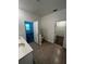 Neutral toned bathroom featuring tiled floors, double sinks, and access to a bedroom and closet at 34071 Sky Blossom Cir, Leesburg, FL 34788