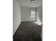 Bright bedroom featuring gray carpet and a window that provides natural light at 34071 Sky Blossom Cir, Leesburg, FL 34788