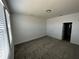 Spacious bedroom with a large window for natural light and neutral colored walls and carpet at 34071 Sky Blossom Cir, Leesburg, FL 34788