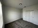 A cozy bedroom featuring gray carpet and a convenient closet with sleek white doors at 34071 Sky Blossom Cir, Leesburg, FL 34788