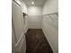 Walk-in closet with metal shelving and neutral colored carpeting at 34071 Sky Blossom Cir, Leesburg, FL 34788