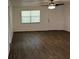 This bedroom features hardwood floors and a modern ceiling fan fixture at 35 Aberdeen Cir, Leesburg, FL 34788