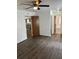 Bedroom boasts hardwood floors, a ceiling fan, and an ensuite bathroom at 35 Aberdeen Cir, Leesburg, FL 34788