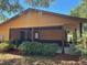 Home featuring covered porch area with well-maintained landscaping at 35 Aberdeen Cir, Leesburg, FL 34788