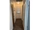 This hallway gives access to rooms and has wood flooring at 35 Aberdeen Cir, Leesburg, FL 34788