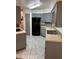 Functional kitchen with gray cabinets, a black refrigerator, and neutral countertops at 35 Aberdeen Cir, Leesburg, FL 34788