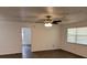 Spacious living room featuring hardwood floors and a ceiling fan fixture at 35 Aberdeen Cir, Leesburg, FL 34788