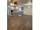 Open-concept living space with wood flooring adjacent to a kitchen at 35 Aberdeen Cir, Leesburg, FL 34788