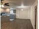 Open-concept living space with wood-look flooring and adjacent kitchen area at 35 Aberdeen Cir, Leesburg, FL 34788