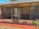 A view of the home's enclosed, screened-in porch area at 35 Aberdeen Cir, Leesburg, FL 34788