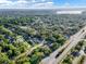 Expansive aerial view showcasing the tranquil neighborhood with mature trees, homes and a nearby community lake at 3517 Merivale Dr, Casselberry, FL 32707