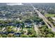 Beautiful aerial view of the property nestled in a lush, green neighborhood with mature trees and a private pool at 3517 Merivale Dr, Casselberry, FL 32707