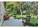 Spacious back patio features ample seating and picturesque views of the lush backyard and mature trees at 3517 Merivale Dr, Casselberry, FL 32707