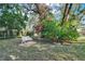 Charming backyard featuring a cozy bench nestled amidst lush greenery, creating a peaceful outdoor escape at 3517 Merivale Dr, Casselberry, FL 32707