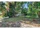 Secluded backyard with mature trees and colorful flowering bushes providing a tranquil and private outdoor retreat at 3517 Merivale Dr, Casselberry, FL 32707