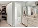 Bright bathroom featuring a vanity with white cabinets and mirrors, along with a separate toilet and walk-in closet at 3517 Merivale Dr, Casselberry, FL 32707
