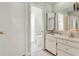 Bright bathroom featuring a vanity with white cabinets and mirrors, along with a separate toilet and shower area at 3517 Merivale Dr, Casselberry, FL 32707