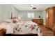 Well-appointed bedroom featuring a floral bedspread, ceiling fan, and hardwood floors at 3517 Merivale Dr, Casselberry, FL 32707