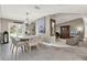 Open concept dining area with chandelier, view into living room and access to patio at 3517 Merivale Dr, Casselberry, FL 32707