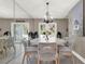 The dining room has French doors, unique chandelier, seating for six, and a large mirror at 3517 Merivale Dr, Casselberry, FL 32707