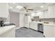 Bright kitchen with white cabinets, stainless steel appliances and gray tile flooring at 3517 Merivale Dr, Casselberry, FL 32707