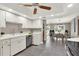 Open-concept kitchen with stainless steel appliances, white cabinetry, and view to the dining area at 3517 Merivale Dr, Casselberry, FL 32707
