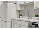 A bright kitchen featuring white cabinets, a stainless steel dishwasher and a white refrigerator at 3517 Merivale Dr, Casselberry, FL 32707