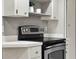 A clean kitchen featuring stainless steel range, with white cabinets and gray countertops at 3517 Merivale Dr, Casselberry, FL 32707