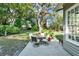 Charming patio area with a dining table set, perfect for enjoying outdoor meals in a serene backyard setting at 3517 Merivale Dr, Casselberry, FL 32707