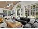 Bright sunroom with large windows, wood ceiling, exercise equipment, comfortable seating, and backyard view at 3517 Merivale Dr, Casselberry, FL 32707