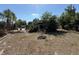 Spacious backyard featuring a pool, patio, and a quaint seating area near the house at 361 Tulip Trl, Casselberry, FL 32707