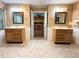 Bright bathroom featuring dual sinks, tile floors and access to the living room at 361 Tulip Trl, Casselberry, FL 32707