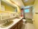 Charming bathroom featuring a dual sink vanity and a tub with a shower, providing comfort and functionality at 361 Tulip Trl, Casselberry, FL 32707
