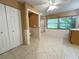 Spacious bathroom featuring tile floors, a toilet, glass-enclosed shower, and natural light from a window at 361 Tulip Trl, Casselberry, FL 32707