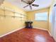 Inviting bedroom with shelving, a window for natural light, ceiling fan, and rich flooring at 361 Tulip Trl, Casselberry, FL 32707