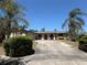 Charming single-story home with a well-maintained lawn and a spacious driveway framed by mature palm trees at 361 Tulip Trl, Casselberry, FL 32707