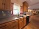 Well-lit kitchen featuring wooden cabinets, granite countertops, and stainless steel appliances for a modern touch at 361 Tulip Trl, Casselberry, FL 32707