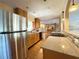 Well-appointed kitchen with modern stainless steel appliances, wood cabinetry, and granite countertops, creating a practical space at 361 Tulip Trl, Casselberry, FL 32707
