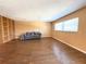 This bright living room features hardwood floors, large windows, and built in shelves at 361 Tulip Trl, Casselberry, FL 32707