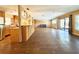 Bright, open-concept living room featuring hardwood floors and access to the kitchen and outdoor space at 361 Tulip Trl, Casselberry, FL 32707