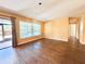 Spacious living room features hardwood floors, large window, and sliding glass door to the outside at 361 Tulip Trl, Casselberry, FL 32707