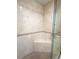 A glass shower with seating provides a refreshing experience enhanced by elegant tile-work at 361 Tulip Trl, Casselberry, FL 32707