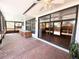 Enclosed sunroom featuring brick floors and sliding glass doors at 361 Tulip Trl, Casselberry, FL 32707