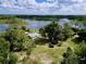 Lush surroundings of the home, featuring mature trees and proximity to the lake in this aerial photograph at 407 Sheryl Dr, Deltona, FL 32738