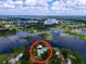 Breathtaking aerial view of the property surrounded by a tranquil lake and lush vegetation at 407 Sheryl Dr, Deltona, FL 32738